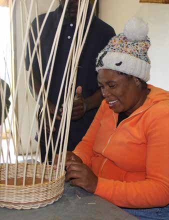 Dory Zuma, who is blind, weaving a cane basket at the Shiyase Disabled Craft Primary Cooperative in Mooi River, KwaZulu-Natal.